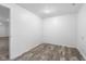 Basement with wood look floors, neutral paint, and good lighting at 1512 Tipton Ln, Columbus, IN 47201