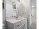 Bathroom vanity with a large mirror and ample lighting next to the hallway at 1512 Tipton Ln, Columbus, IN 47201