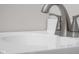 Close-up of a bathroom sink featuring a chrome faucet and a white countertop with sleek, modern design elements at 1512 Tipton Ln, Columbus, IN 47201