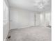 Spacious carpeted bedroom with a ceiling fan, neutral walls, and multiple closets for ample storage and lots of light at 1512 Tipton Ln, Columbus, IN 47201