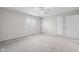 Neutrally painted bedroom with carpeted floors, window views, and a ceiling fan at 1512 Tipton Ln, Columbus, IN 47201