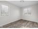 Bedroom featuring light wood-look flooring and two windows at 1512 Tipton Ln, Columbus, IN 47201