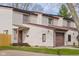 A row of two-story condos with vinyl siding, single car garages, and well-maintained lawns at 1512 Tipton Ln, Columbus, IN 47201