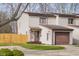 Charming townhouse with brown trim, an attached garage, and a cozy front porch at 1512 Tipton Ln, Columbus, IN 47201