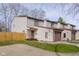Traditional townhouse with a two-car garage, neutral vinyl siding and a private entry at 1512 Tipton Ln, Columbus, IN 47201