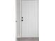 A white six-panel front door with black hardware stands out against a light gray wall at 1512 Tipton Ln, Columbus, IN 47201