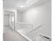 Bright hallway with carpeted stairs, fresh paint, and modern lighting create a welcoming and pristine atmosphere at 1512 Tipton Ln, Columbus, IN 47201