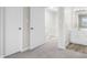 Hallway with carpet flooring leading to bedrooms and bathroom, creates a cohesive and inviting space for modern living at 1512 Tipton Ln, Columbus, IN 47201