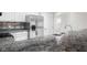 Kitchen featuring a stainless steel refrigerator, sink, dark countertops, and white cabinets at 1512 Tipton Ln, Columbus, IN 47201