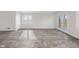 Open-concept living room with luxury floors, natural light, and glass paneled patio doors at 1512 Tipton Ln, Columbus, IN 47201