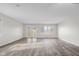 Open-concept living room with natural lighting, luxury floors and glass paneled patio door at 1512 Tipton Ln, Columbus, IN 47201