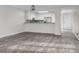 Open-concept living room featuring luxury floors and a view into the eat-in kitchen area at 1512 Tipton Ln, Columbus, IN 47201