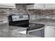 Close-up of a stainless steel and black electric range with a ceramic cooktop and digital controls at 1512 Tipton Ln, Columbus, IN 47201