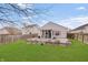Large backyard featuring a patio area and a well-maintained lawn at 15433 Wandering Way, Noblesville, IN 46060