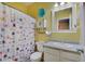 Bright bathroom with colorful floral shower curtain at 15433 Wandering Way, Noblesville, IN 46060