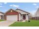 Charming single-Gathering home with red brick accents, attached garage, and well-maintained lawn at 15433 Wandering Way, Noblesville, IN 46060