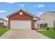 Charming home with a brick facade and attached two-car garage, curb appeal at 15433 Wandering Way, Noblesville, IN 46060