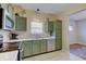 Traditional kitchen with green cabinets, modern appliances, and an eat-in breakfast nook at 15433 Wandering Way, Noblesville, IN 46060