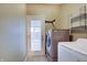 Efficient laundry room with a washer, dryer, and access to the backyard at 15433 Wandering Way, Noblesville, IN 46060