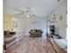 Inviting living room featuring hardwood floors, a ceiling fan, and comfortable seating at 15433 Wandering Way, Noblesville, IN 46060