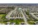 Expansive aerial view of a residential community featuring well-maintained homes and a central pond at 15679 Woodford Dr, Westfield, IN 46074