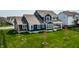 Aerial view of a home with lush lawn, complemented by young trees and neighboring houses, set in a welcoming community at 15679 Woodford Dr, Westfield, IN 46074
