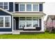 Covered back porch featuring cozy seating and elegant lighting, enhancing outdoor living space and curb appeal at 15679 Woodford Dr, Westfield, IN 46074
