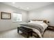Cozy bedroom featuring a large window, wood-framed mirror, comfortable bed, and stylish bench, creating a serene retreat at 15679 Woodford Dr, Westfield, IN 46074