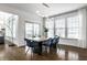 Bright dining room features hardwood floors, modern lighting and a large window overlooking the backyard at 15679 Woodford Dr, Westfield, IN 46074