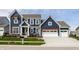 Stunning two-story home with blue siding, white trim, manicured lawn, and a spacious three-car garage at 15679 Woodford Dr, Westfield, IN 46074
