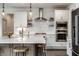 Well-appointed kitchen with gas range, built-in oven, marble countertops, and stainless steel appliances at 15679 Woodford Dr, Westfield, IN 46074