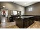 Spacious area showcasing a dark kitchen island with granite countertops at 15679 Woodford Dr, Westfield, IN 46074