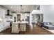Open-concept kitchen with white cabinetry, an island with stool seating, and an open view of the staircase at 15679 Woodford Dr, Westfield, IN 46074