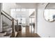 Open-concept living area with hardwood floors, staircase, and a glimpse of the dining area at 15679 Woodford Dr, Westfield, IN 46074