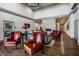 Elegant lounge area featuring wood floors, leather seating, and a stone fireplace at 15679 Woodford Dr, Westfield, IN 46074