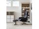 Cozy office nook featuring a gray chair with an ottoman, bookshelf, and storage at 15679 Woodford Dr, Westfield, IN 46074