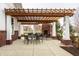 Inviting outdoor patio with a wooden pergola, brick fireplace, and comfortable seating at 15679 Woodford Dr, Westfield, IN 46074