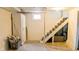 This unfinished basement has a staircase, small window, and a cement floor, awaiting personalization at 1627 E 8Th St, Anderson, IN 46012