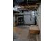 Unfinished basement featuring exposed pipes and ducts, a window, shelving, and concrete floor at 1627 E 8Th St, Anderson, IN 46012