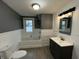 Bathroom featuring combination tub and shower, modern vanity, tile, and wood-look flooring at 1627 E 8Th St, Anderson, IN 46012
