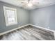 Relaxing bedroom with neutral colors, modern flooring, and ample natural light for a serene retreat at 1627 E 8Th St, Anderson, IN 46012