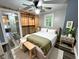 Bedroom with neutral color palette, wood-look flooring, ceiling fan, and closet with shelving at 1627 E 8Th St, Anderson, IN 46012
