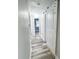 Hallway with modern flooring and white trim, leading to various rooms in the house at 1627 E 8Th St, Anderson, IN 46012