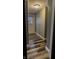 Hallway featuring laminate flooring leading to a white door with window at 1627 E 8Th St, Anderson, IN 46012