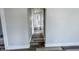 Narrow hallway featuring gray walls and flooring, offering access to multiple rooms in the home at 1627 E 8Th St, Anderson, IN 46012