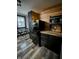 A kitchen with black cabinets, wood countertop, stainless steel appliances and a dining area by the window at 1627 E 8Th St, Anderson, IN 46012