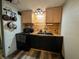Charming kitchen with wood backsplash, a sleek black sink and cabinets with stainless steel hardware at 1627 E 8Th St, Anderson, IN 46012