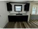 Contemporary kitchen features dark cabinets, sleek countertops, and a stainless steel sink at 1627 E 8Th St, Anderson, IN 46012