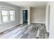 Inviting living area with new flooring, large window, and neutral paint, ready for personal touches at 1627 E 8Th St, Anderson, IN 46012