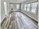 Spacious living room with large windows providing natural light, featuring modern flooring at 1627 E 8Th St, Anderson, IN 46012